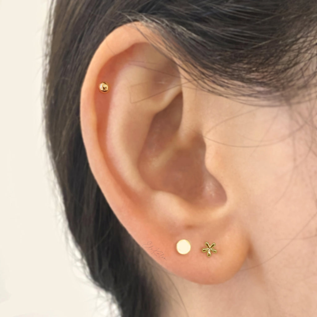 Cute mini daisy flower stud earrings handcrafted in 10K yellow gold.